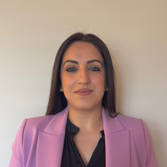 Professional headshot image of a woman wearing a pink jacket