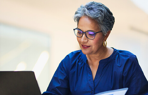 An older woman working on her laptop