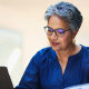 An older woman working on her laptop