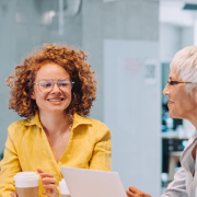 A diverse group of people in a professional setting, smiling at each other