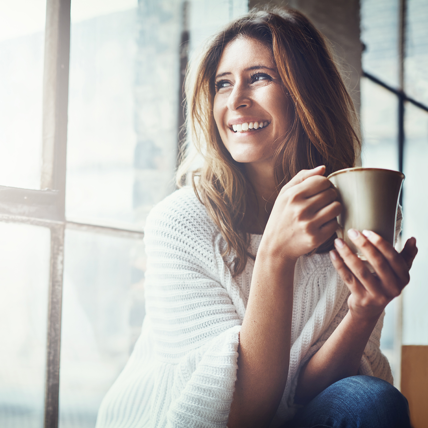 Smiling woman holding coffee cup