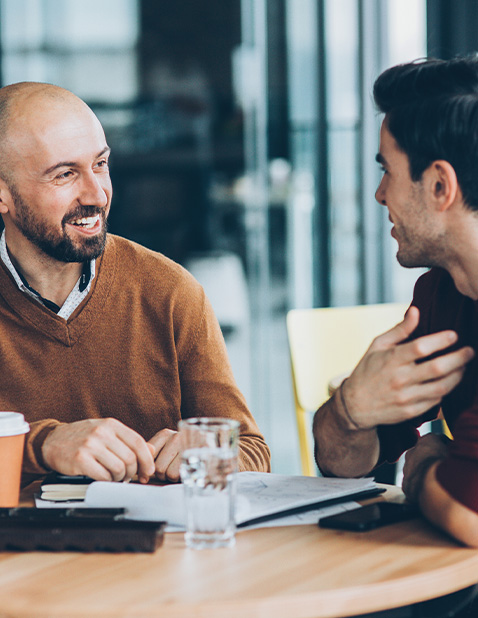 Office worker talking with psychologist over coffee about employee support