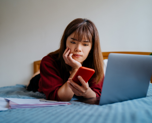 Teenager on bed experiencing cyberbullying