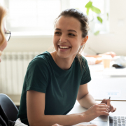 Two women at a desk creating workplace mental health policy