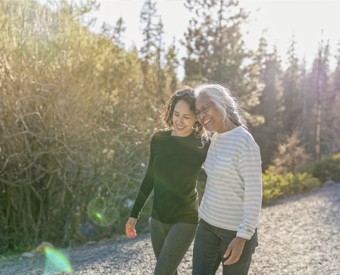 Woman helping her friend with mental health issues at Christmas by taking her on a walk outside