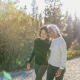 Woman helping her friend with mental health issues at Christmas by taking her on a walk outside