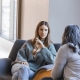 Woman in wooly jumper talking to mental health psychologist