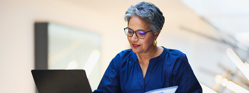 An older woman working on her laptop