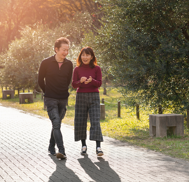 A man and woman walking in a park