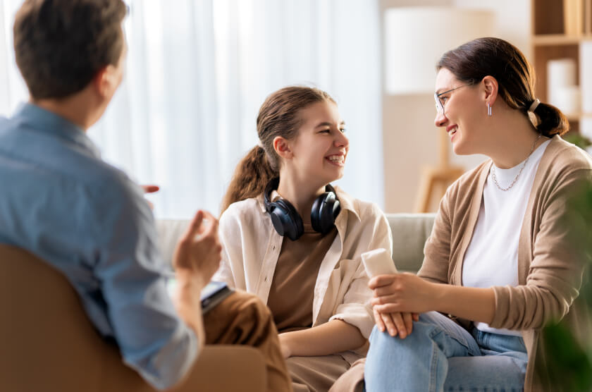 Photo of a teenager and parent visiting a clinician